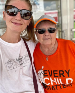 Karleigh Csordas with a woman wearing an orange T-shirt with the words "Every Child Matters"