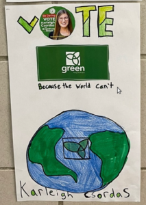 Hand-drawn poster : "VOTE" (with a Karleigh Csordas campaign button where the O should be), the Green Party of Ontario logo above the words "Because the world can't";  a blue and green drawing of the globe with a GPO logo at the centre and "Karleigh Csordas" below.